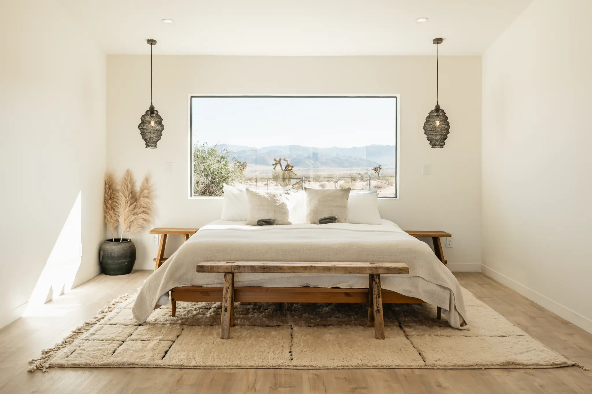 SaguaroHaus — king bedroom with panoramic desert window and Moroccan pendants