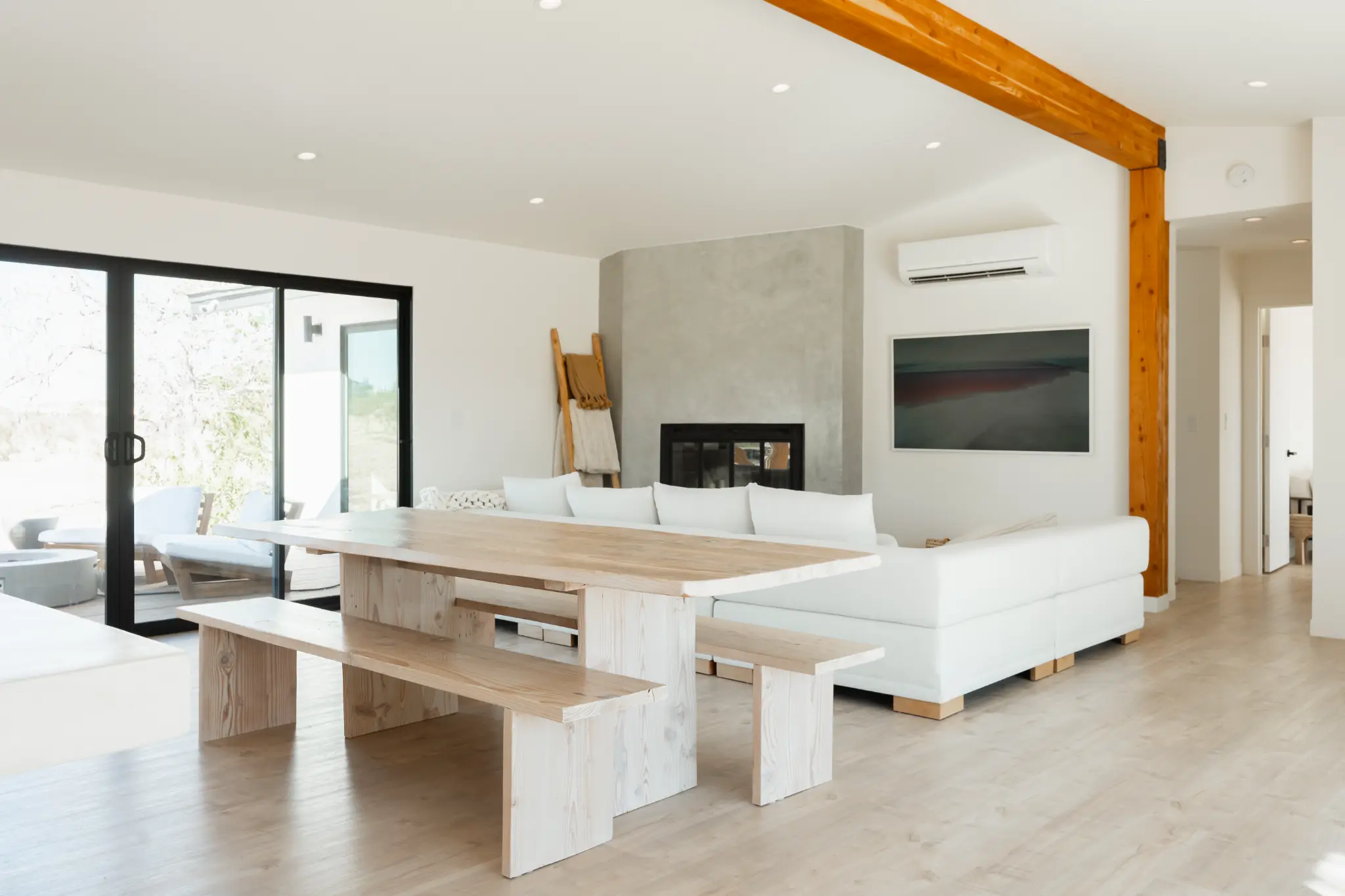 Reclaimed wood dining table with benches, open-plan living